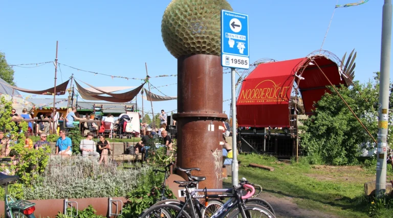 Sunny terrace and red entrance at Caf&eacute; Noorderlicht on Amsterdam NDSM wharf, May 2016