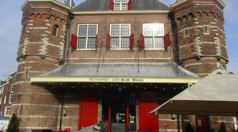 Historic brick fa&ccedil;ade and red shutters of Restaurant-Caf&eacute; In de Waag on Nieuwmarkt in Amsterdam