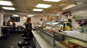 Customers at the counter and sandwich display inside Eetsalon Van Dobben in Amsterdam, photographed in 2009