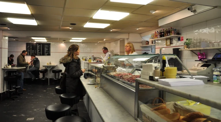 Customers at the counter and sandwich display inside Eetsalon Van Dobben in Amsterdam, photographed in 2009