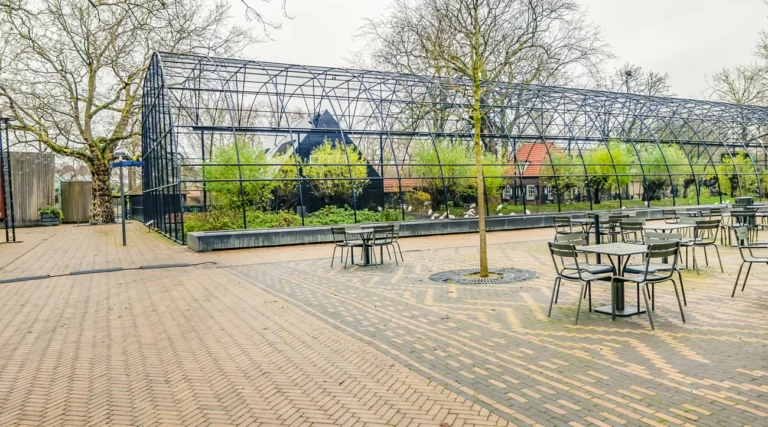 ARTISplein in Amsterdam with the long Watertafel water-feature edge beside the Hollandse Polder aviary and outdoor seating in daylight