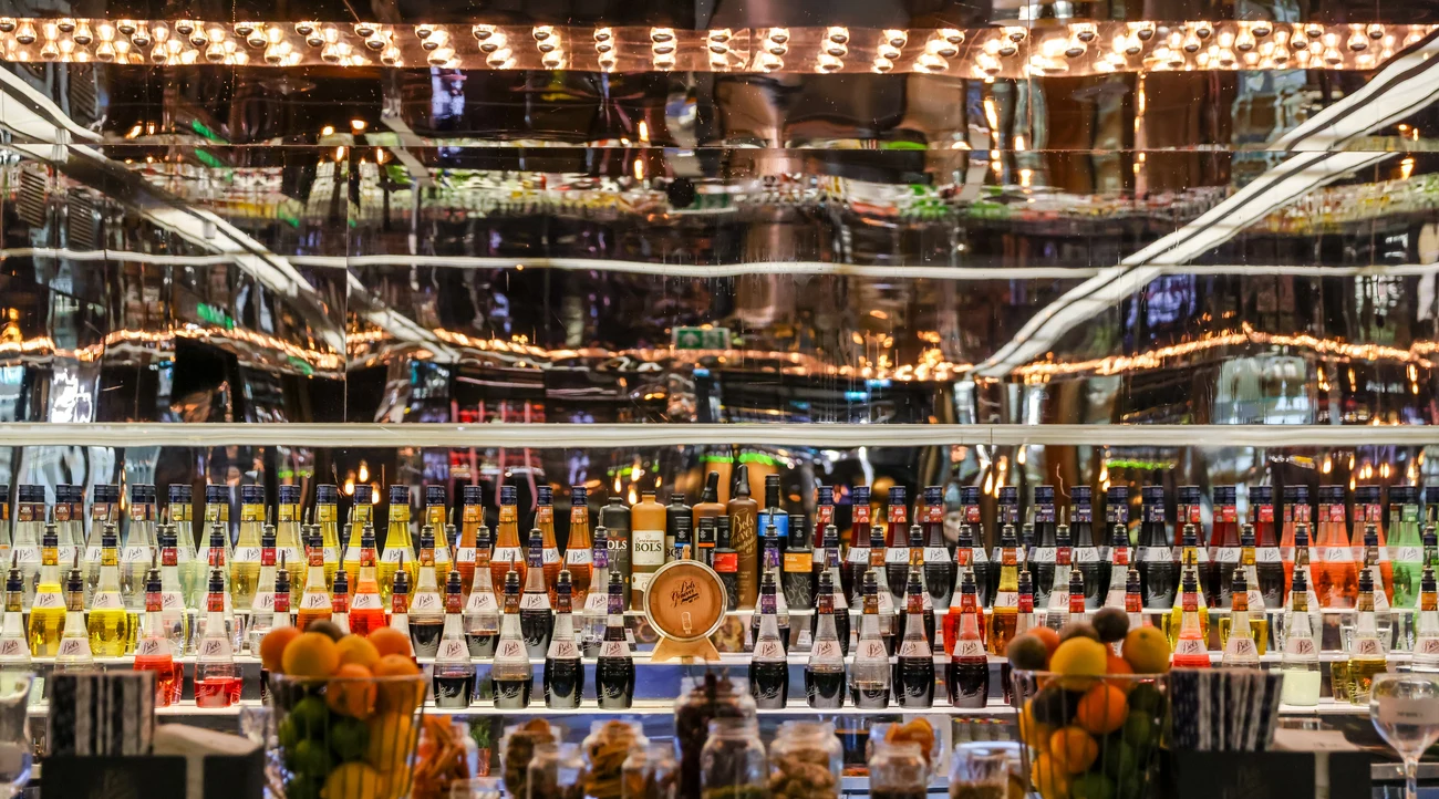 Colourful bottles and mirrored ceiling at the House of Bols cocktail bar in Amsterdam