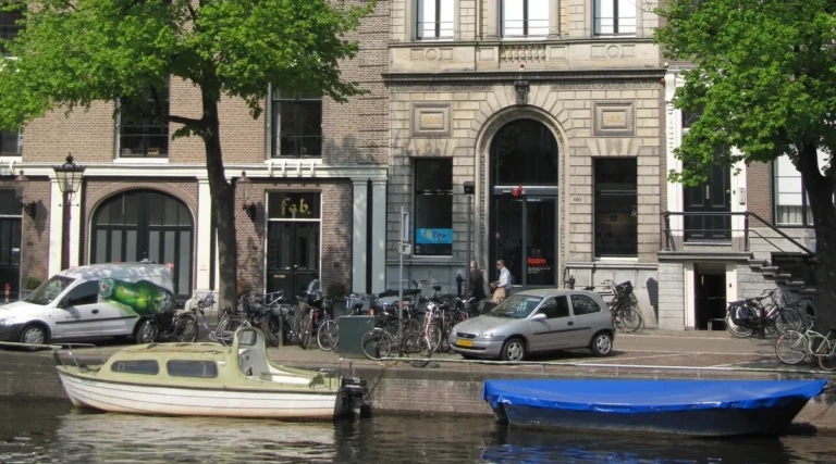 Foam photography museum entrance on Keizersgracht in Amsterdam, with boats on the canal in daylight