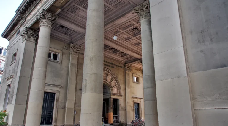 Corinthian columns and decorated wooden ceiling of Haarlemmerpoort in Amsterdam in daylight
