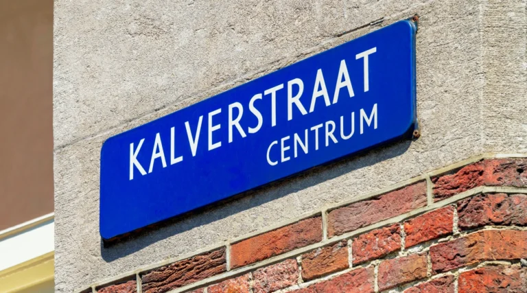 Blue Kalverstraat Centrum street sign on a brick facade in Amsterdam in daylight