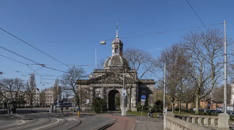 Muiderpoort city gate and its cupola beside Alexanderplein in Amsterdam under a blue daytime sky