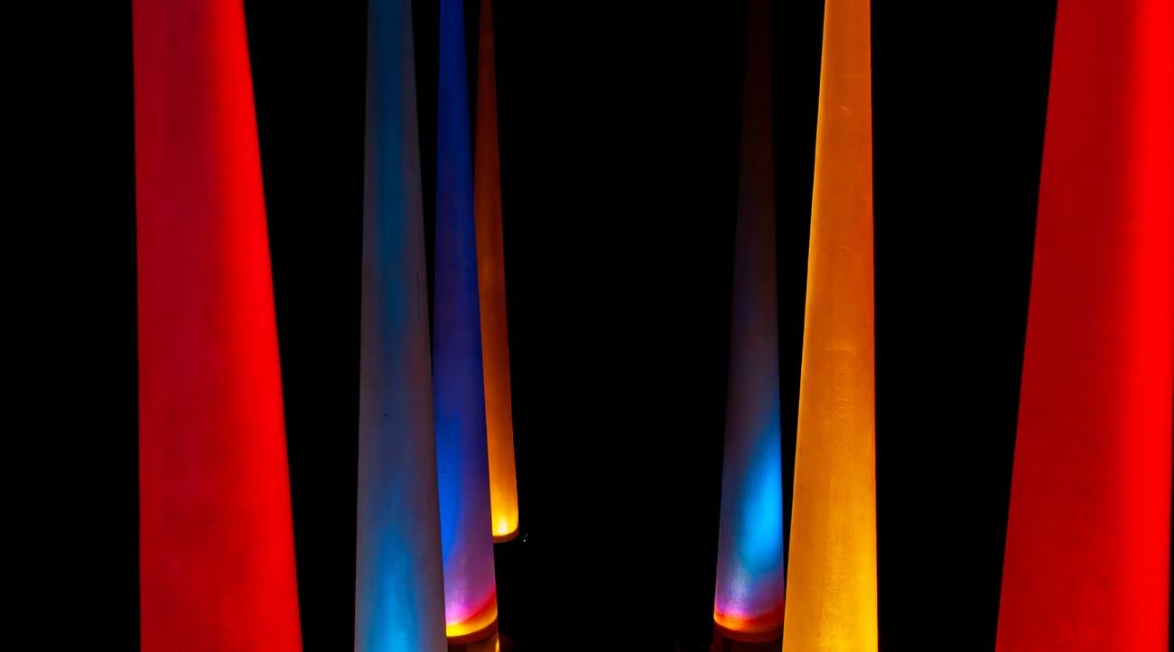 Illustrative art installation with red, blue and orange illuminated geometric forms