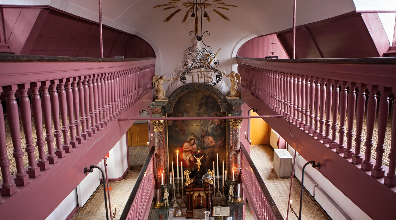 Pink galleries and altar inside Our Lord in the Attic Church in Amsterdam