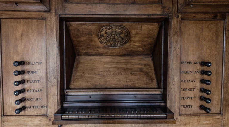 Wooden organ console with keyboard and labelled stops inside Our Lord in the Attic Museum in Amsterdam