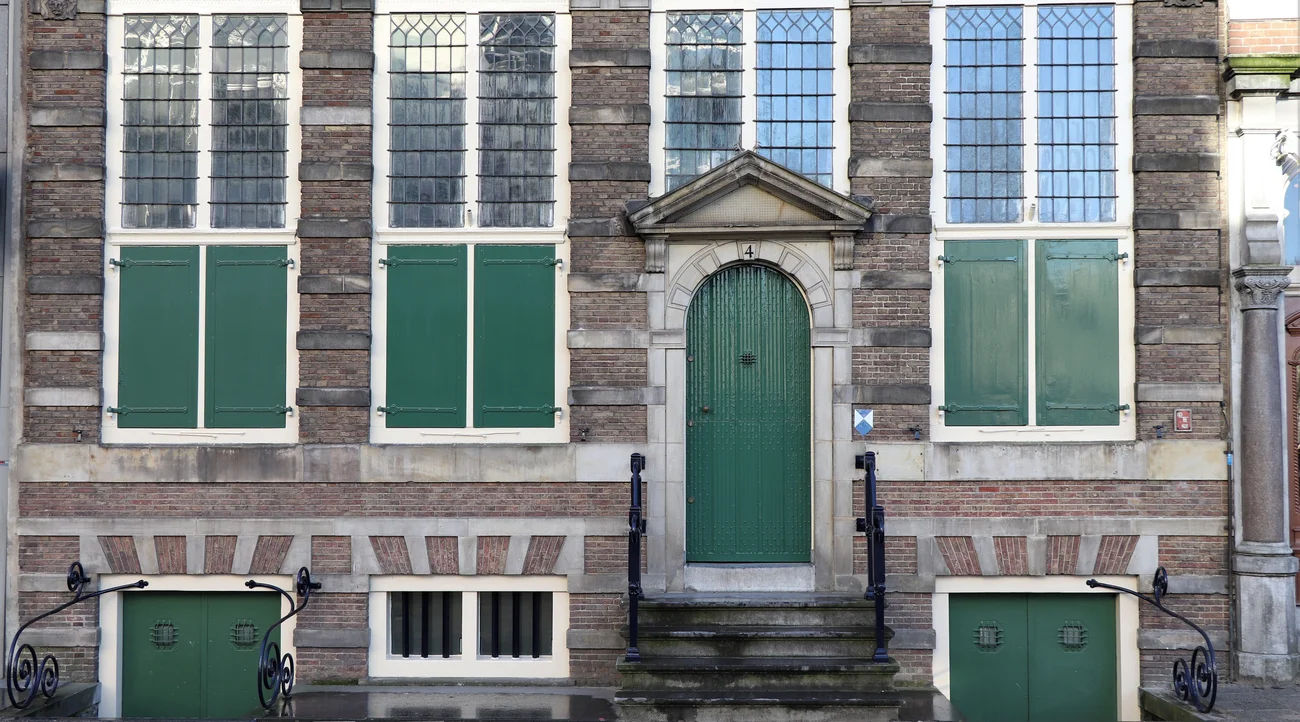 Green entrance door and shutters on the historic facade of the Rembrandt House Museum in Amsterdam