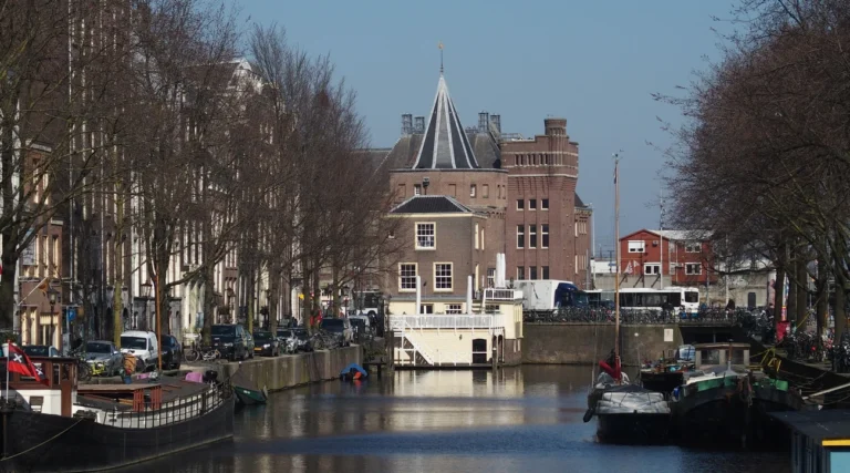 Schreierstoren medieval harbour tower at the end of a canal in Amsterdam during daylight