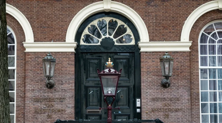 Decorated entrance and lanterns of the Maagdenhuis on Spui square in Amsterdam in daylight