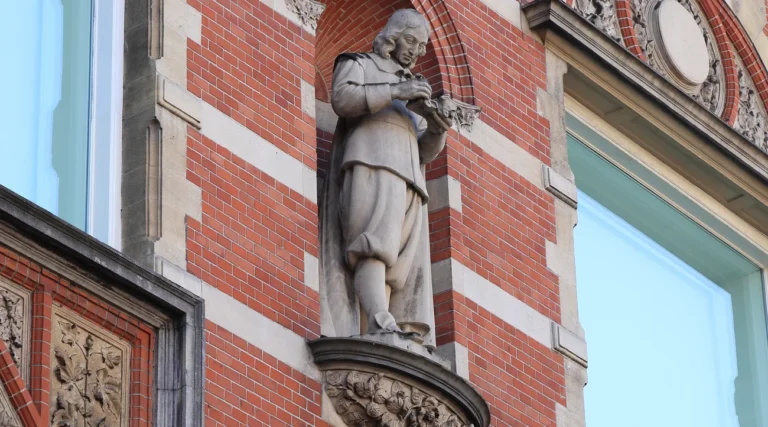 Sculpted figure and red brick details on the historic facade of the Stedelijk Museum in Amsterdam